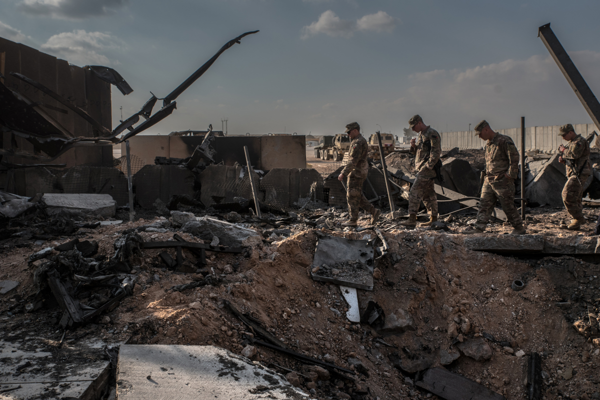 U.S. officials stand near a crater caused by Iranian airstrikes inside the Ain al-Asad base near Anbar, Iraq, on Jan. 13, 2019. MUST CREDIT: Photo for The Washington Post by Emilienne Malfatto