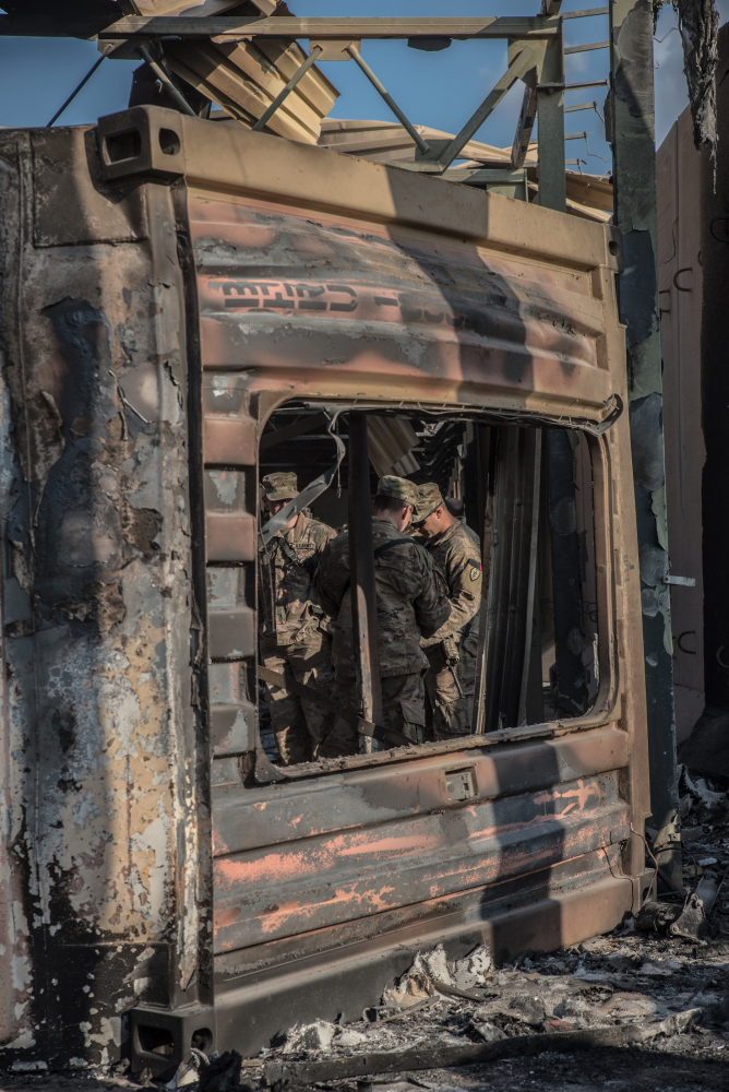 U.S. officials stand near an installation hit by Iranian airstrikes inside the Ain al-Asad base near Anbar, Iraq, on Jan. 13, 2019. MUST CREDIT: Photo for The Washington Post by Emilienne Malfatto