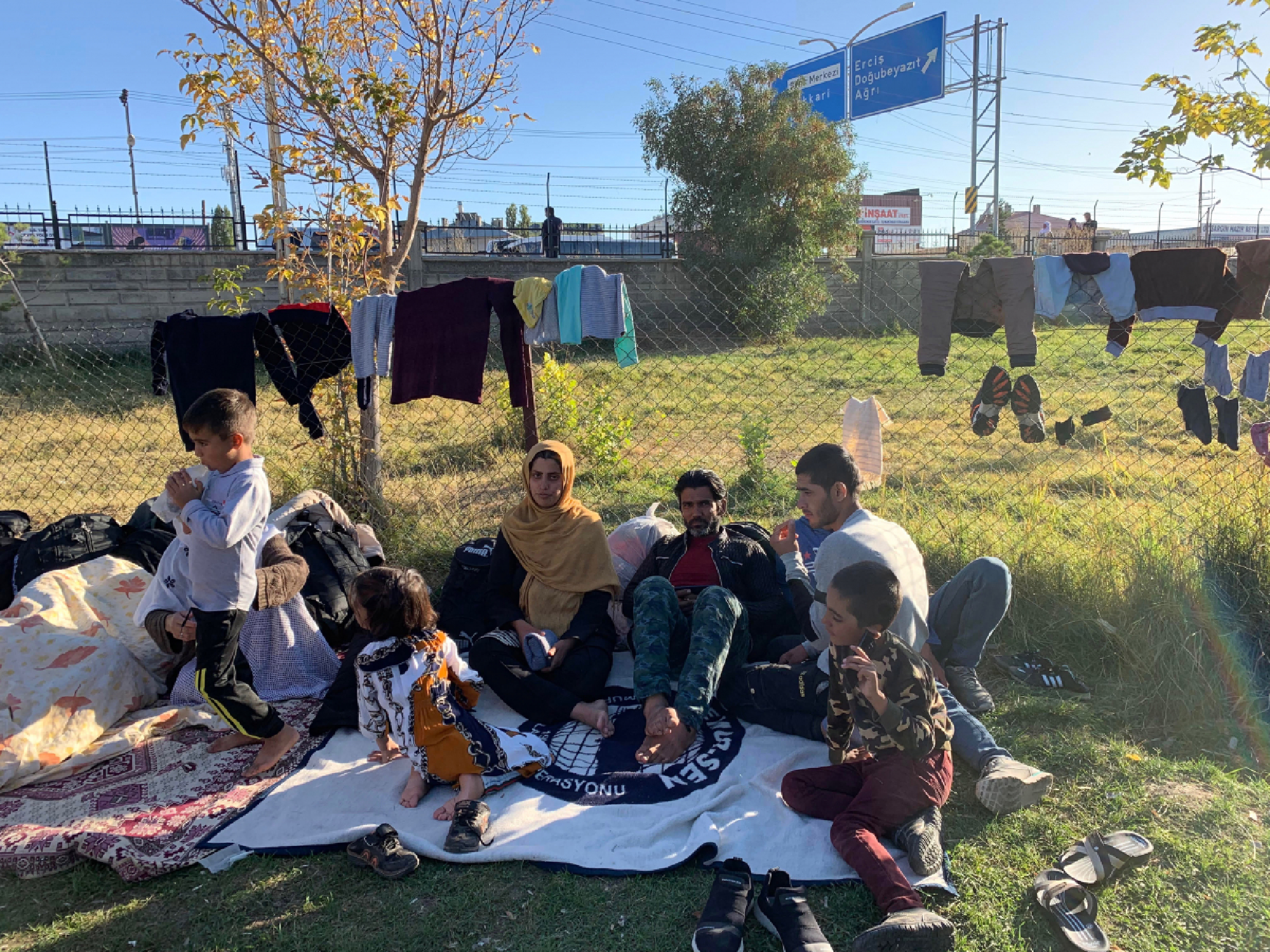 Samira Tajik, shown wearing a yellow headscarf, lived for years in Iran after fleeing conflict in Afghanistan. Tajik, 24, and her extended family, including her husband and three children, recently crossed into Turkey. This grassy lot at the bus station in Van, a city in eastern Turkey, now is a de facto camp for Afghan refugees. MUST CREDIT: Washington Post photo by Erin Cunningham
