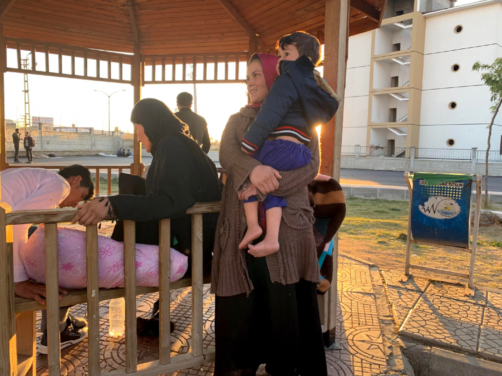 Members of an extended family from Afghanistan's Kunduz province rest at a gazebo at the bus station in Van. Police have ordered the refugees to squat at the station while authorities prepare to register the new arrivals. MUST CREDIT: Washington Post photo by Erin Cunningham