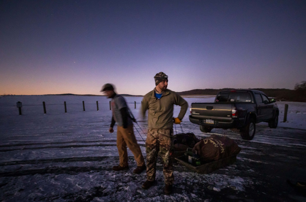 Adam Saurazas, left, and Nick Semanco haul sleds of hunting equipment tin the Middle Creek Wildlife Management Area in Stevens, Pennsylvania, on Jan. 9, 2020. MUST CREDIT: Photo for The Washington Post by Kyle Grantham