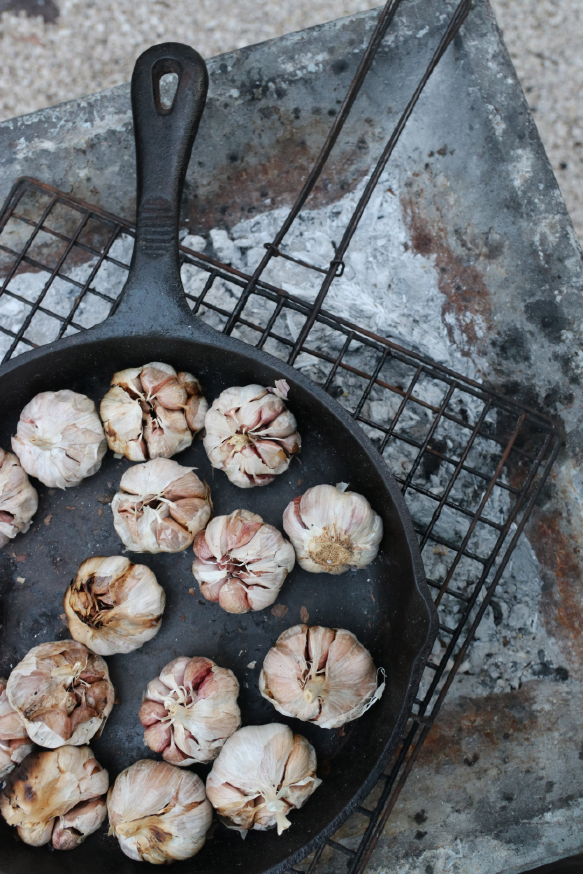 Garlic roasting over the outdoor fire-pit at Safari Tulum in Tulum, Mexico. MUST CREDIT: Photo for The Washington Post by Nevin Martell