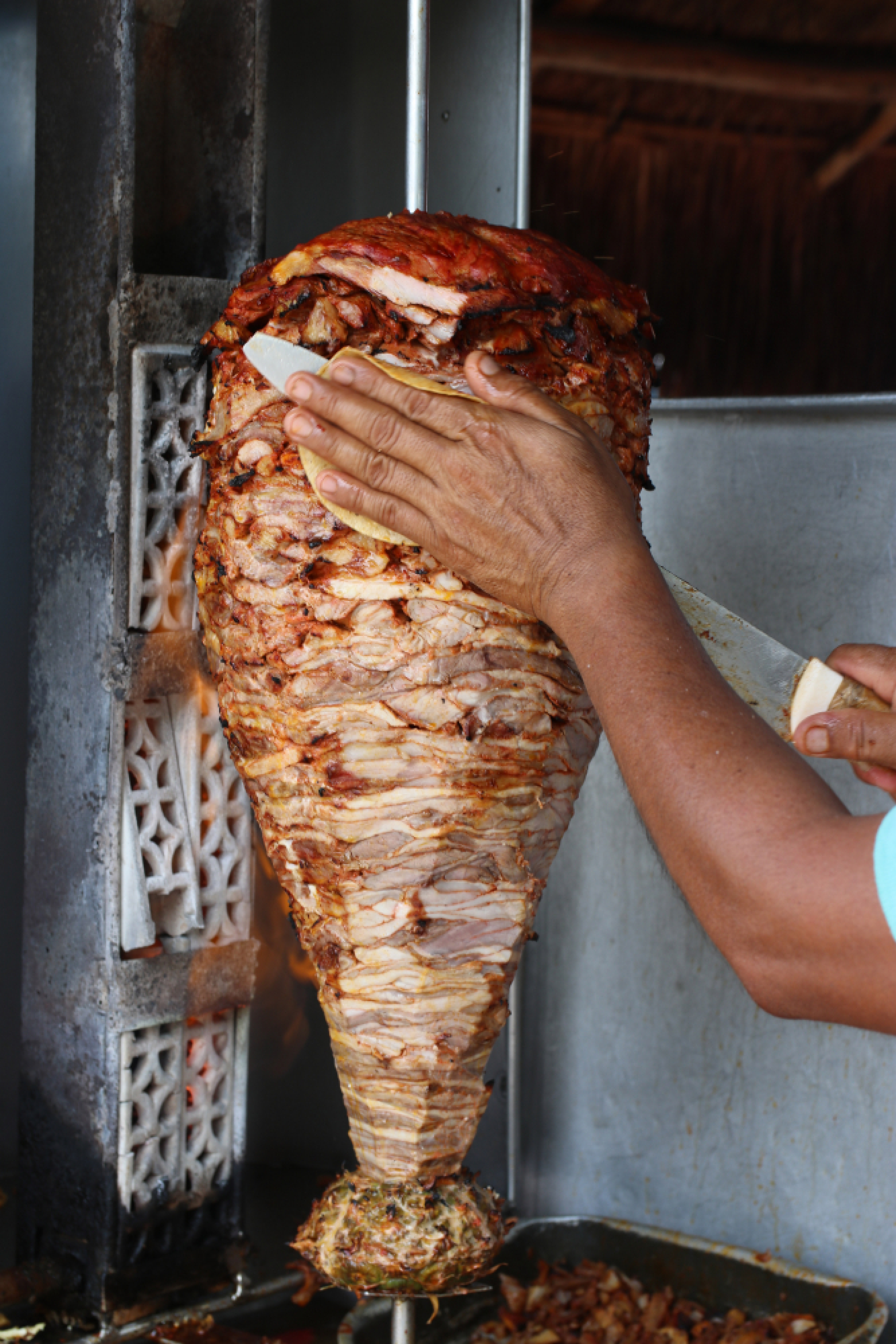 Slicing off pork for al pastor tacos at La Chiapaneca in Tulum, Mexico. MUST CREDIT: Photo for The Washington Post by Nevin Martell