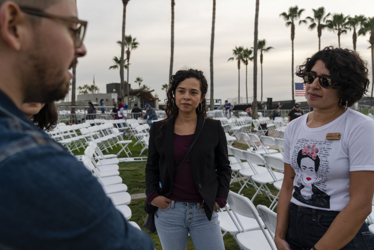 Steven Almazan, 28, an education policy consultant; Leslie Dávila, 34, a Spanish literature and language professor; and Frances Dávila, 31, speak with one another after the Bernie Sanders rally. MUST CREDIT: Photo by Philip Cheung for The Washington Post