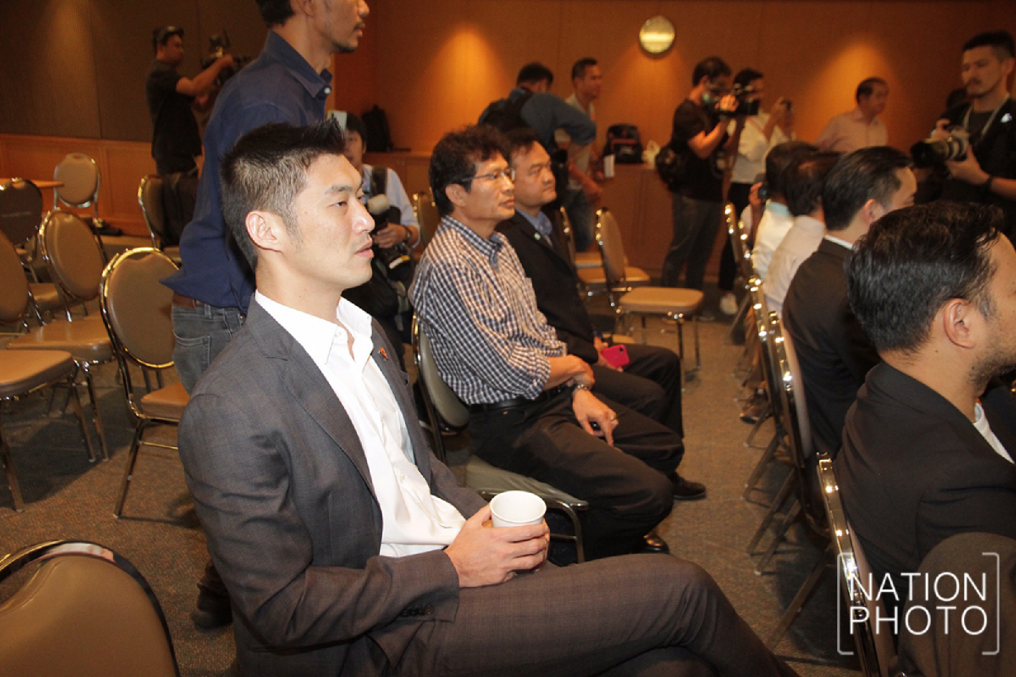Thanathorn Juangroongruangkit watches the court’s verdict read on TV at party headquarters.