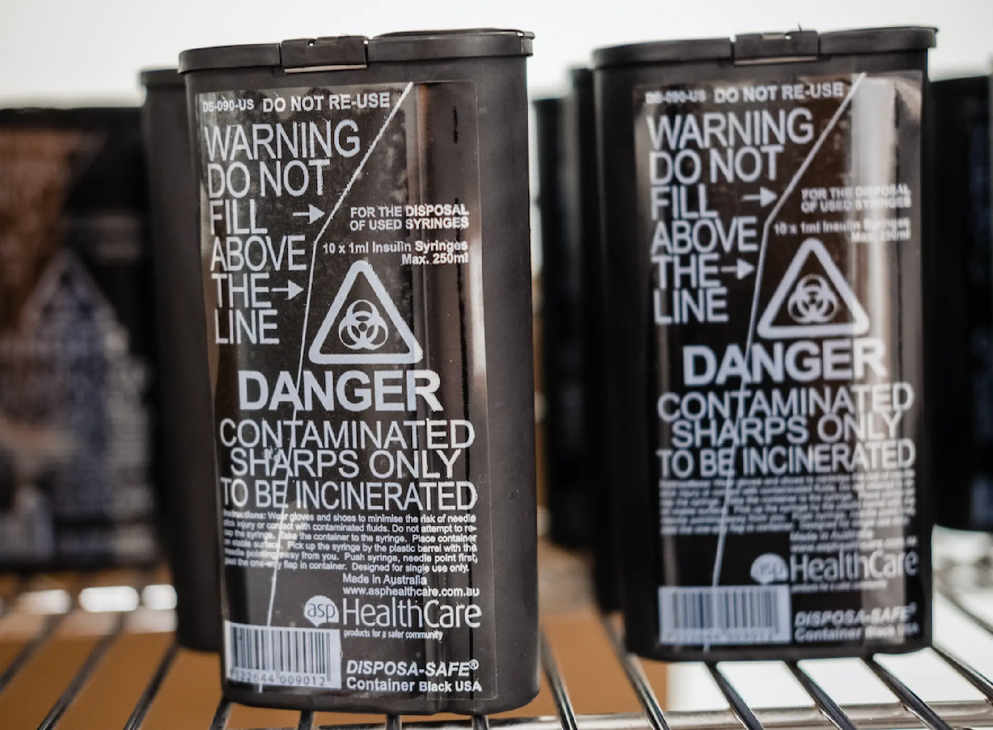 Syringe disposal cans line a shelf in an office at GLIDE, a multi-service social center in San Francisco. MUST CREDIT: Photo by Nick Otto for The Washington Post.