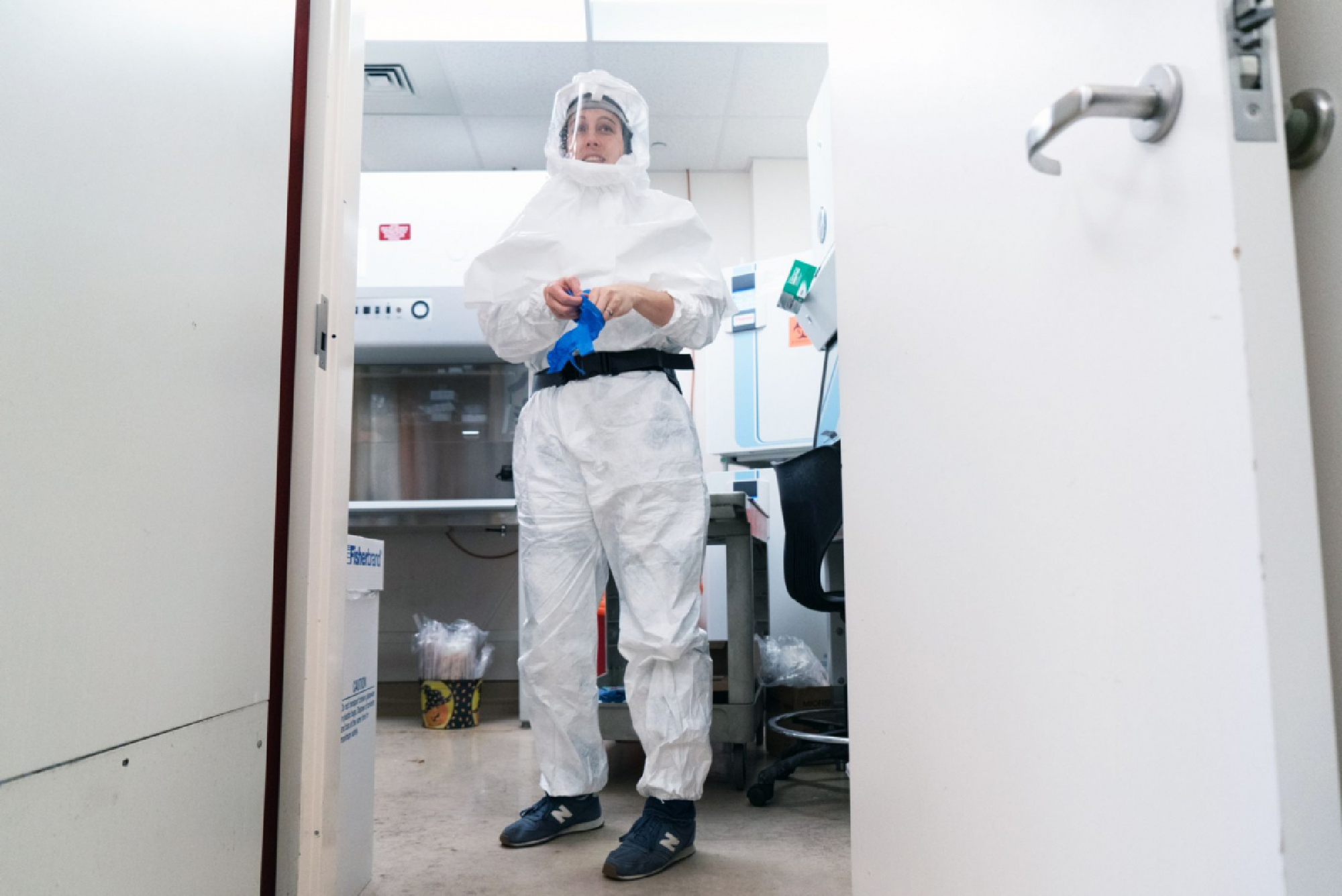 Lisa Gralinski, assistant professor on the virology team, suits up. MUST CREDIT: Bloomberg photo by Christopher Janaro