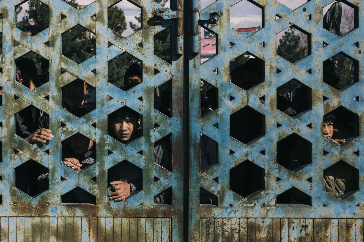 Onlookers observe the site of an attack, claimed by ISIS, in Kabul on Friday. MUST CREDIT: Photo by Lorenzo Tugnoli for The Washington Post