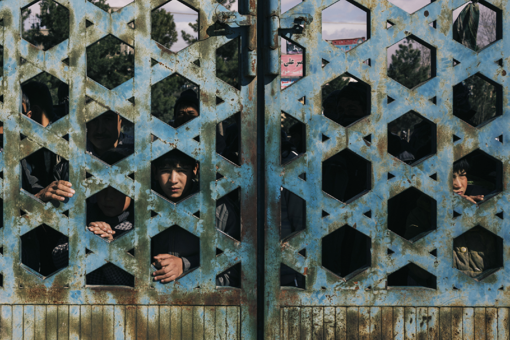 Onlookers observe the site of an attack, claimed by ISIS, in Kabul on Friday. MUST CREDIT: Photo by Lorenzo Tugnoli for The Washington Post