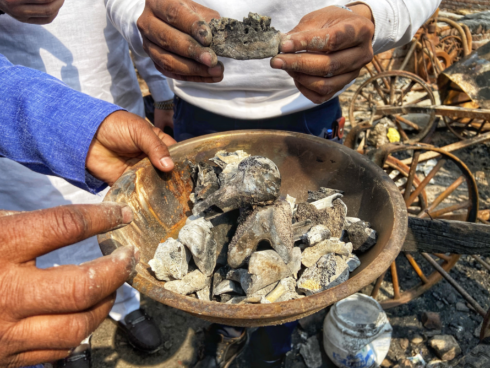 Saleem Kassar holding up the bones he picked from the site where his brother was killed. MUST CREDIT: Washington Post photo by Niha Masih
