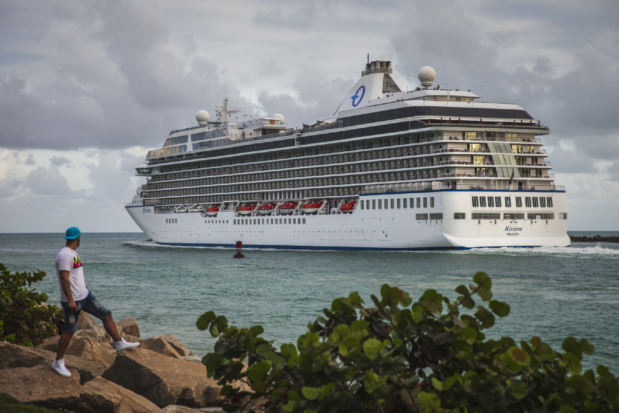 People watch as a cruise ship departs to the Atlantic Ocean from South Pointe Park in Miami Beach on Wednesday. MUST CREDIT: photo for The Washington Post by Scott McIntyre.