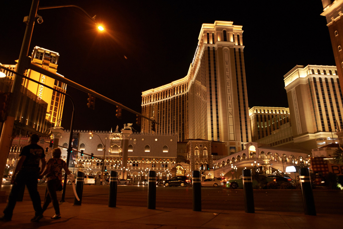 Pedestrians pass in front of the Las Vegas Sands Venetian resort illuminated at night in Las Vegas, Nevada, on April 24, 2018. MUST CREDIT: Bloomberg photo by Bridget Bennett