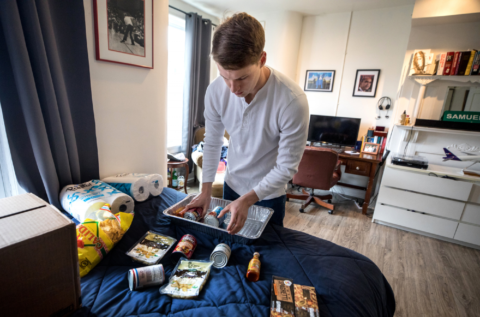 Zach Lane has stocked up on nonperishable food and toilet paper. MUST CREDIT: Photo for The Washington Post by Evelyn Hockstein