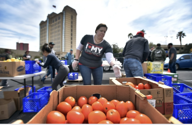 Volunteers load boxes of food at an emergency food distribution site in the parking lot of the Palace Station hotel-casino in the city. MUST CREDIT: Photo by David Becker for The Washington Post