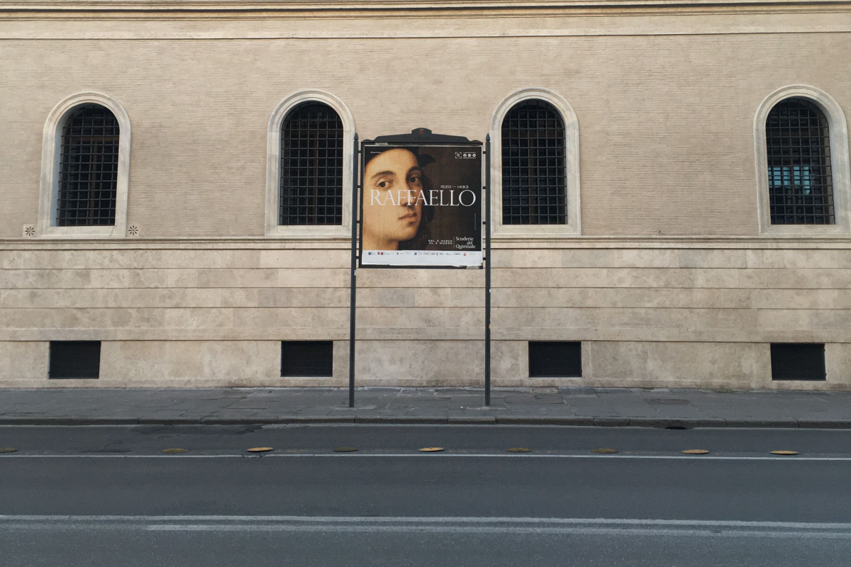 A forsaken Roman street features a Raphael billboard. MUST CREDIT: Bloomberg photo by Vernon Silver.