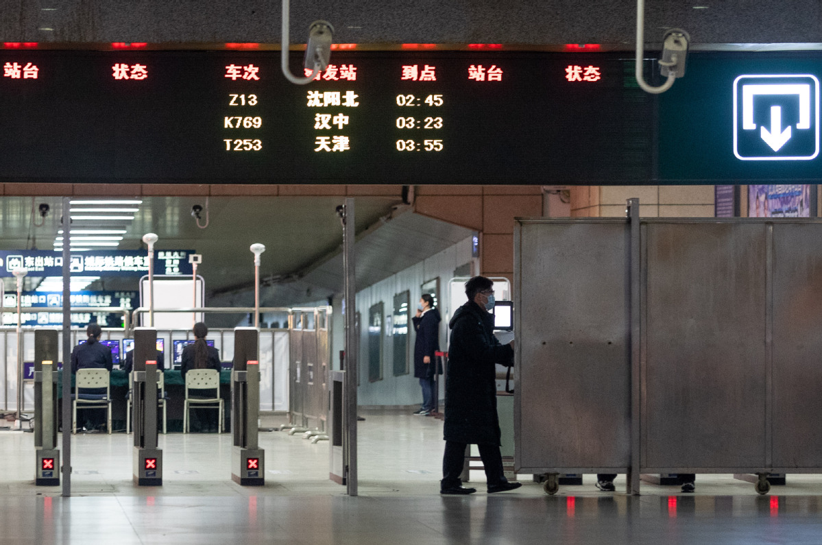 A staff member opens the shutters at Wuchang Railway Station in Wuhan, Central China's Hubei province, as the city restarts its railway service, on March 28, 2020. [Photo by Ke Hao/chinadaily.com.cn]
