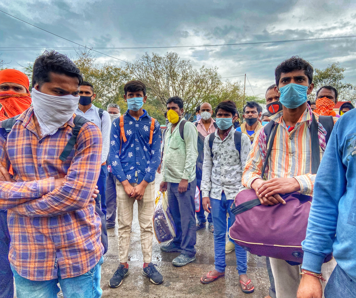 Chandra Mohan, right, a plumber working in a Delhi suburb, is walking to his village, 680 miles away in another state. Hundreds of migrants like him have been forced to leave the capital as jobs have disappeared. Mohan is shown March 27, 2020, leaving New Delhi. PHOTO CREDIT: Washington Post photo by Niha Masih
