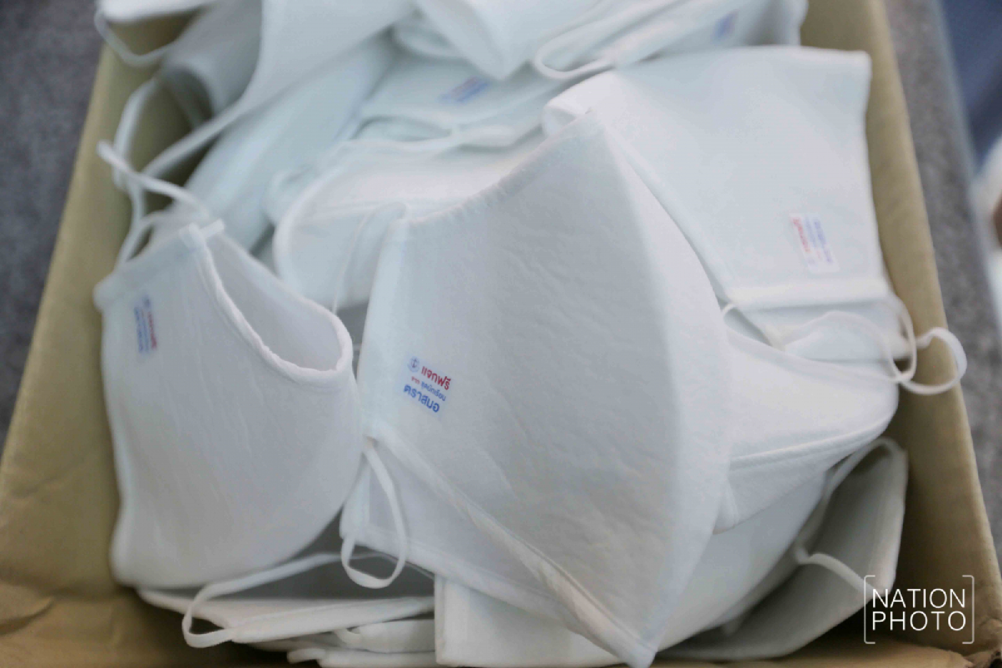Student wear maker handing out face masks with three layers
