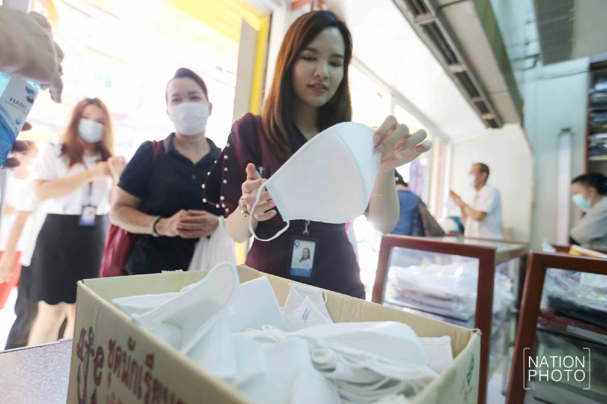 Student wear maker handing out face masks with three layers