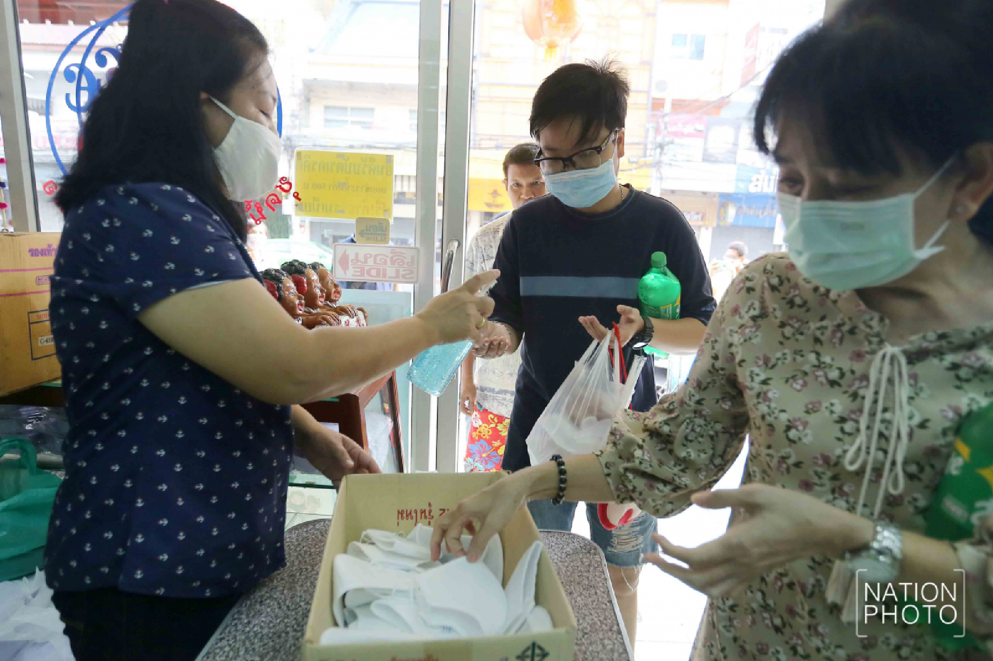 Student wear maker handing out face masks with three layers