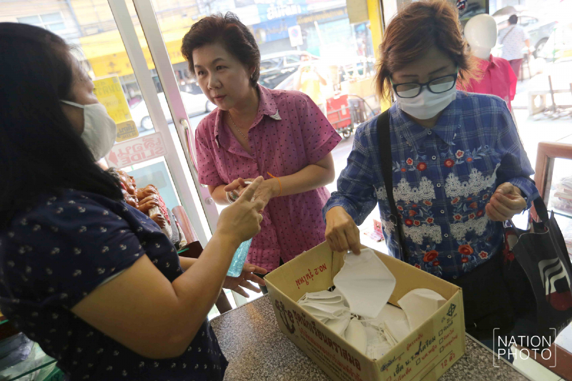Student wear maker handing out face masks with three layers
