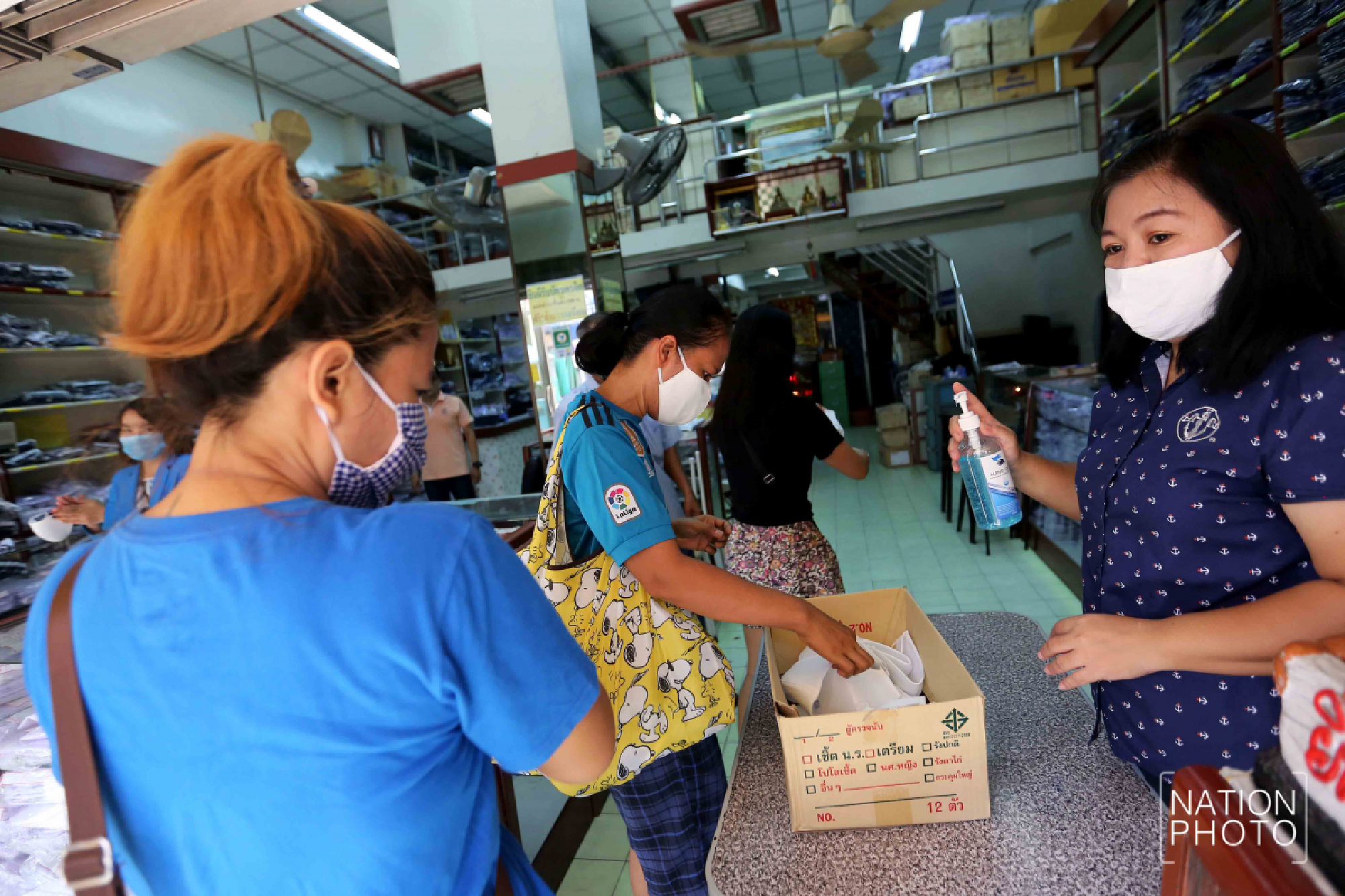 Student wear maker handing out face masks with three layers