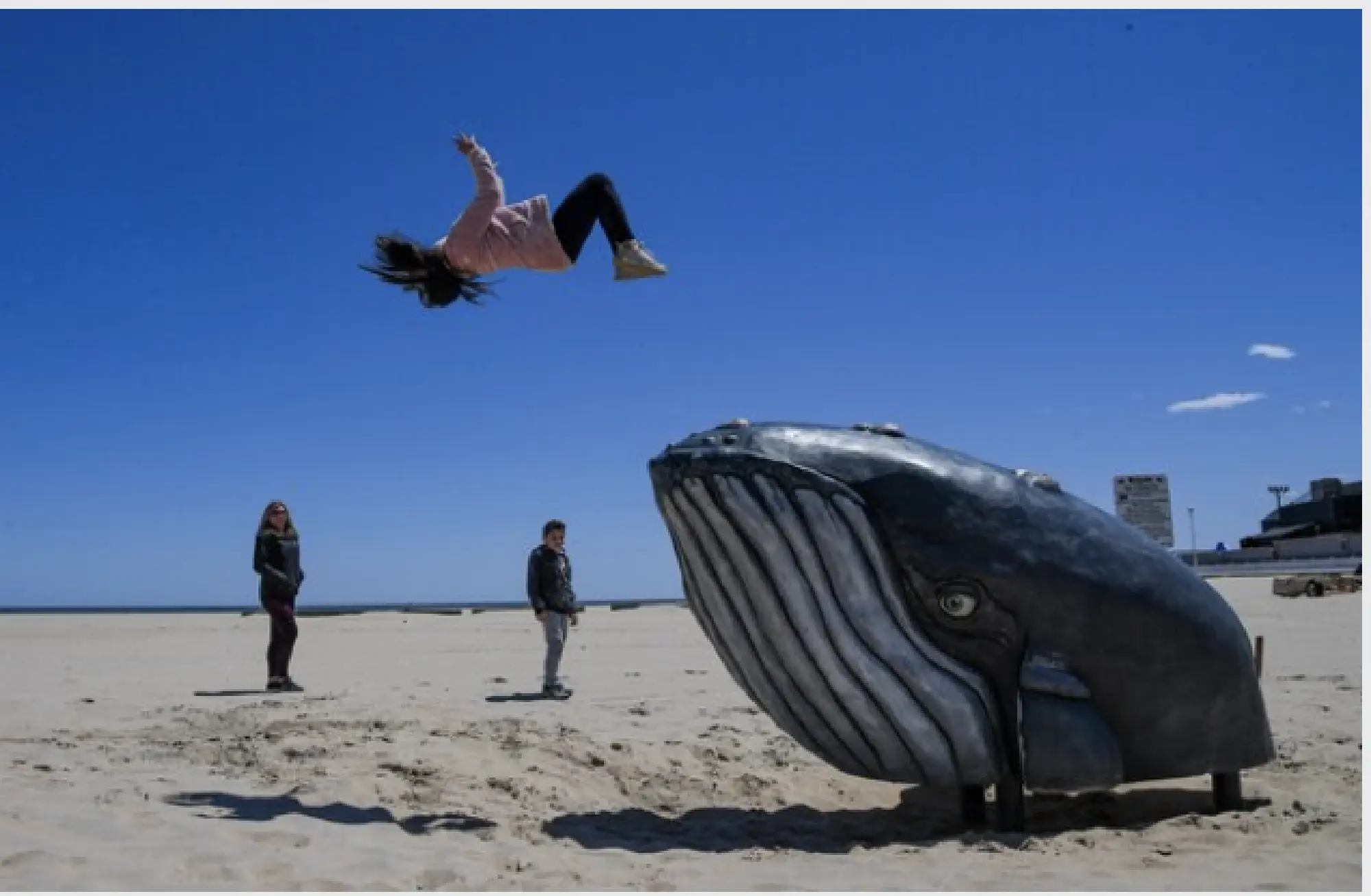 Eleni Kaliakoudas, 12, does a backflip off a whale in Ocean City, Md., on Saturday. MUST CREDIT: Washington Post photo by Jonathan Newton
