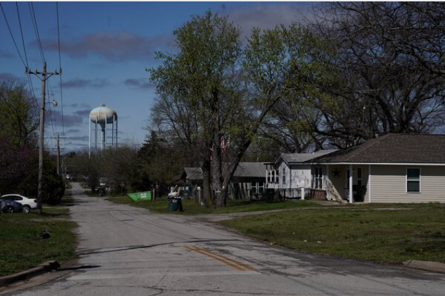 A water tower looms over a neighborhood in Bristow, Okla., March 24. MUST CREDIT: Photo for The Washington Post by Nick Oxford