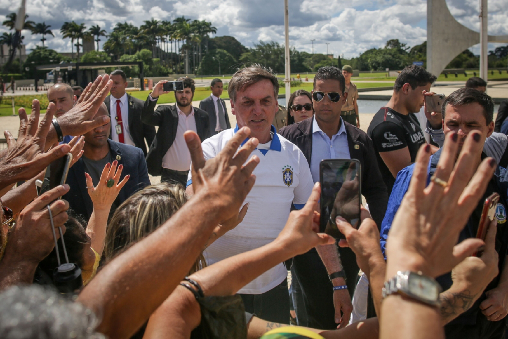 Brazilian President Jair Bolsonaro greets supporters during a demonstration outside of the Planalto Palace in Brasilia, Brazil, on March 15, 2020. MUST CREDIT: Bloomberg photo by Andre Coelho