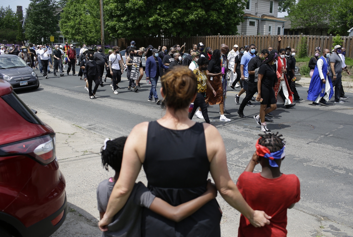 Clergy members march Tuesday in Minneapolis, where George Floyd died in police custody. His hometown, Houston, was host to one of the day's largest peaceful protests. MUST CREDIT: Photo by Joshua Lott for The Washington Post