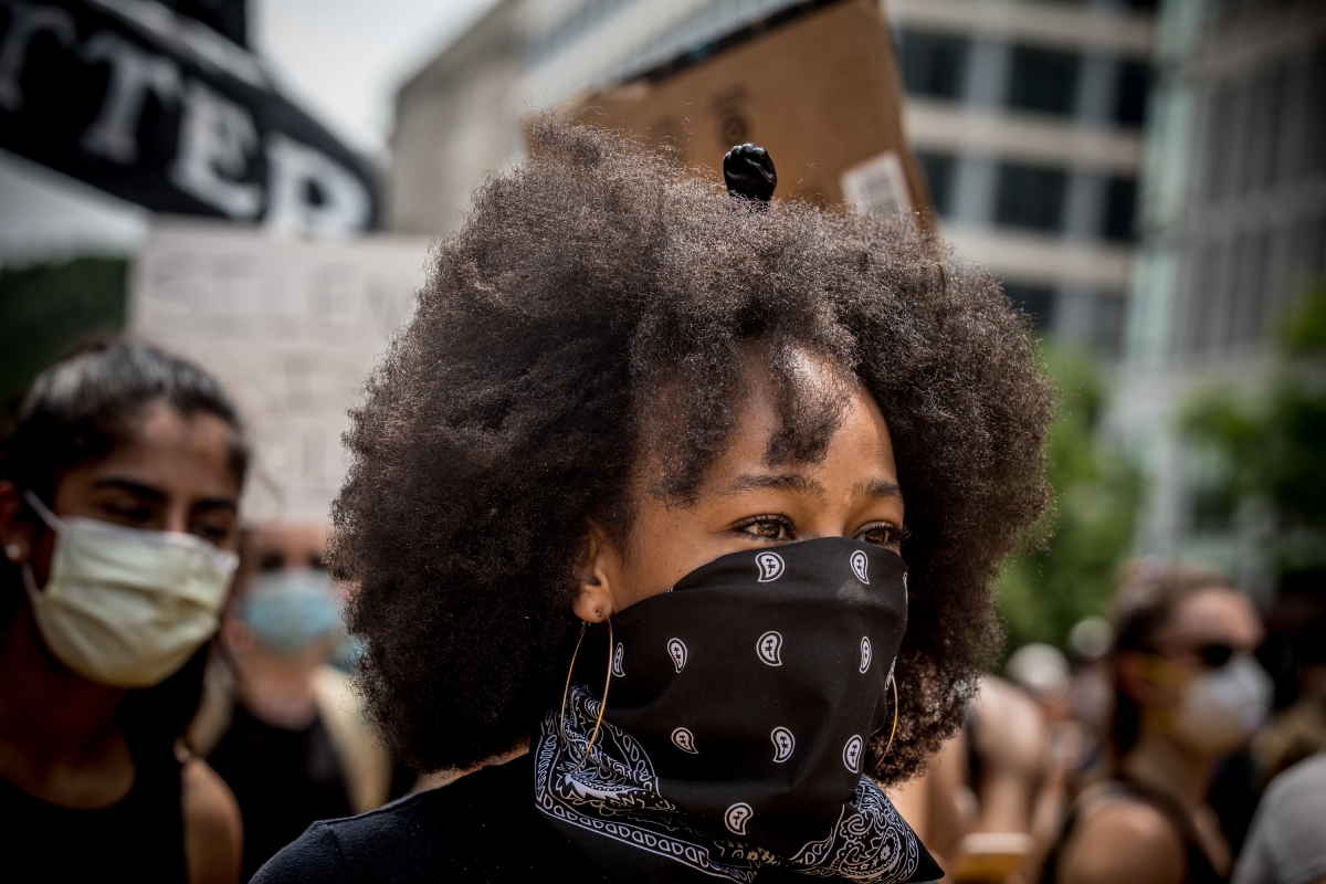 A black power hair comb is worn by a demonstrator outside of the White House in Washington, D.C., on Saturday. MUST CREDIT: Photo by Evelyn Hockstein for The Washington Post