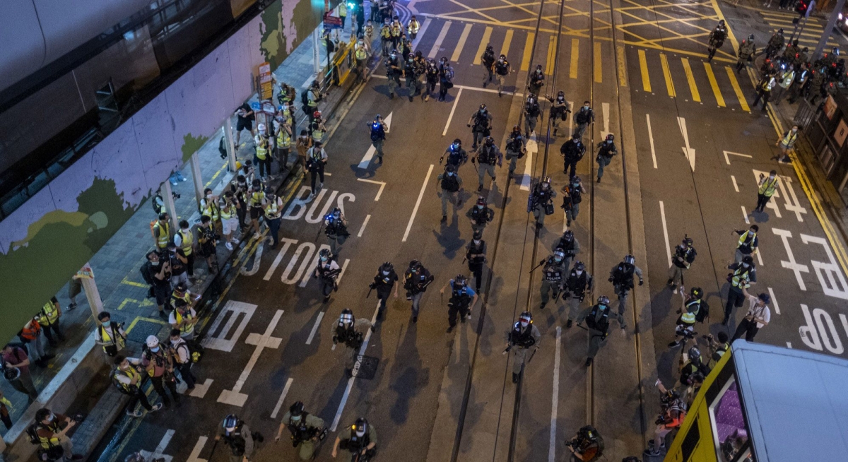 Riot police charge in an attempt to disperse demonstrators on Des Voeux Road during a protest in Hong Kong on June 9, 2020. MUST CREDIT: Bloomberg photo by Justin Chin P