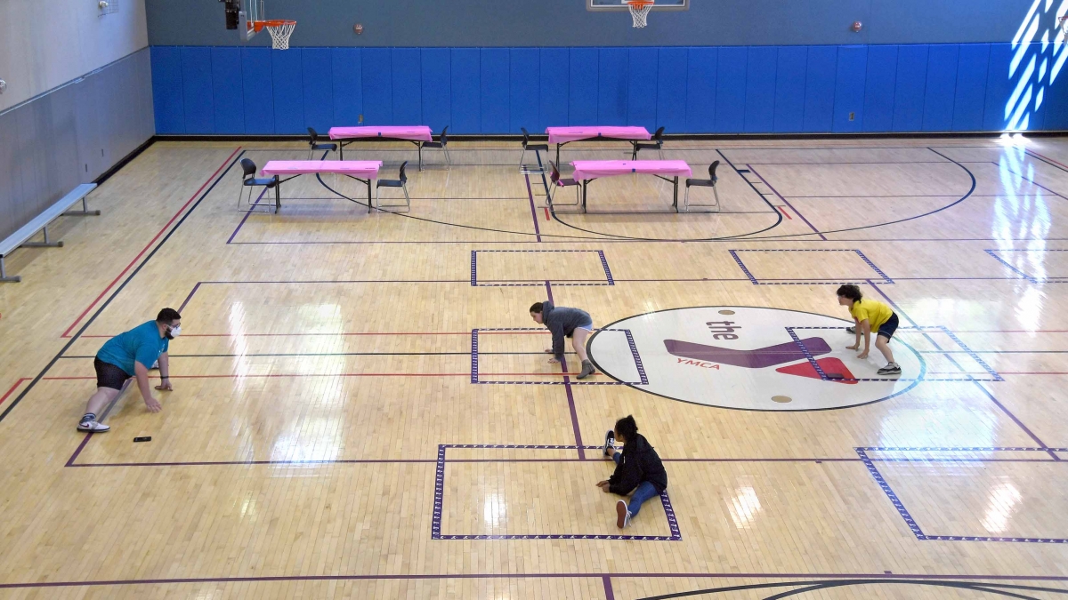 Counselor Aryan Shal, a YMCA counselor, leads children with some moves for a "Jedi Knight" exercise class on June 12, 2020, at the YMCA in Ellicott City, Md. MUST CREDIT: Washington Post photo by Michael S. Williamson