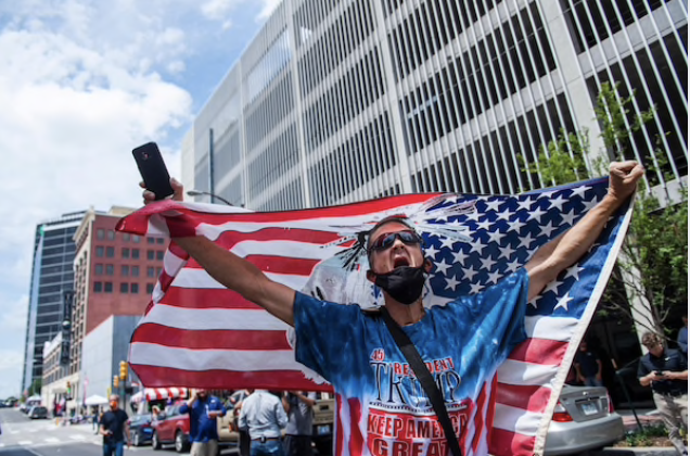 A Trump supporter engages with counterprotesters near the entrance of the BOK Center on Saturday afternoon in Tulsa, Okla. MUST CREDIT: Photo by Amanda Voisard for The Washington Post