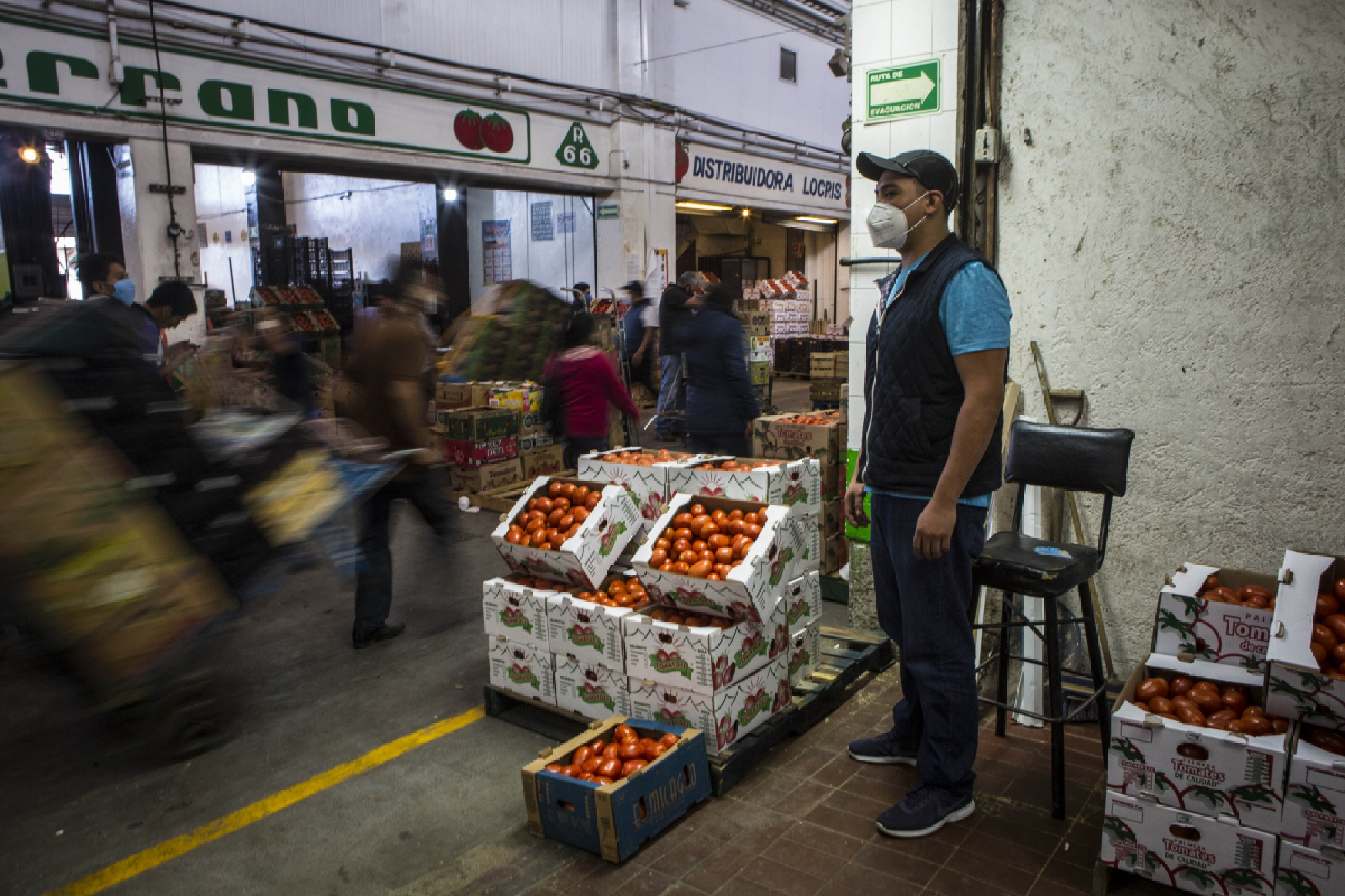 Carlos Molina, 31, whose father, Martin Mateo, 50, died of covid-19,, stands at the entrance of his family's tomato stall at the Central de Abastos in Mexico City on June 12, 2020. MUST CREDIT: Photo for The Washington Post by Jane Hahn