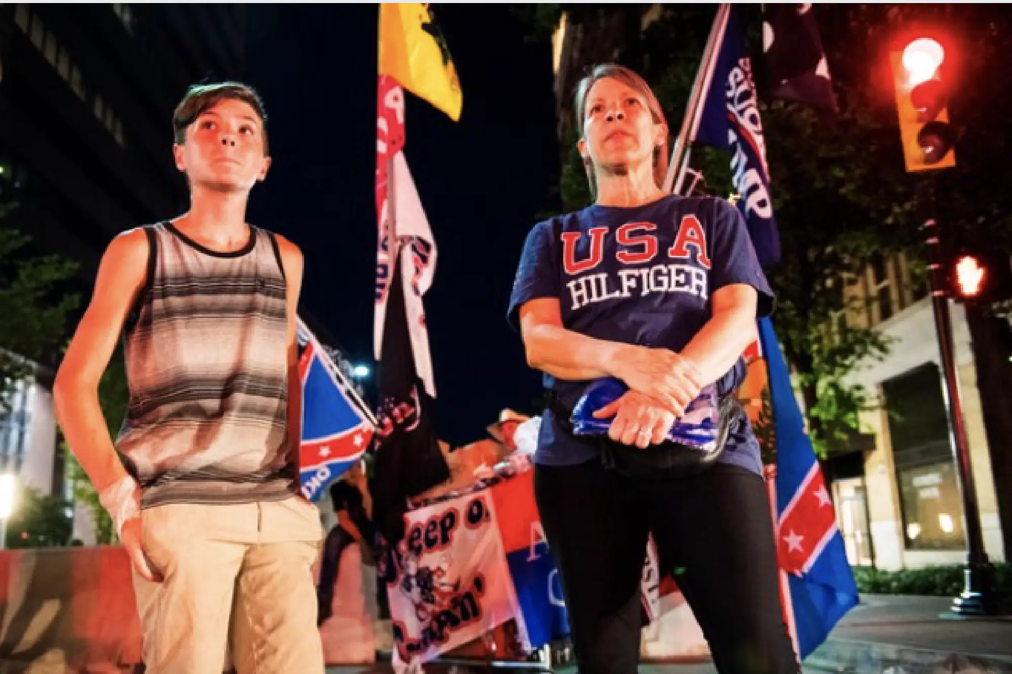 Anne Harrison and her grandson Logan Renfro, 13, of Fayetteville, Ark., watch the perimiter of the BOK Center in Tulsa, Okla., during President Donald Trump's rally on Saturday, June 20, 2020. MUST CREDIT: Photo for The Washington Post by Amanda Voisard