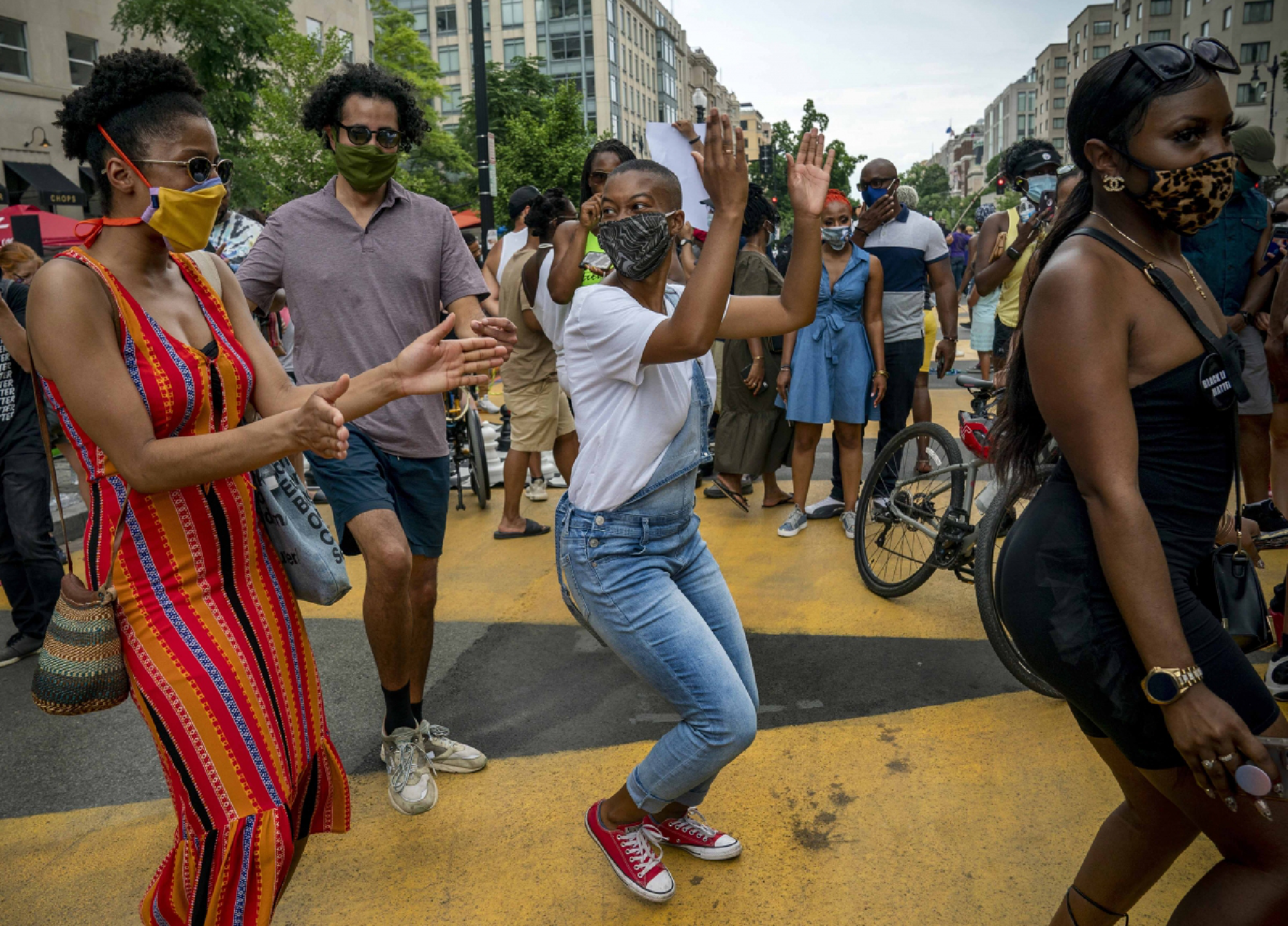 Crowds dance and enjoy live music on 16th Street amidst a joyous atmosphere during DC's Chocolate City Experience around Black Lives Matter Plaza, June 27, 2020, in Washington. MUST CREDIT: Photo for The Washington Post by Evelyn Hockstein
