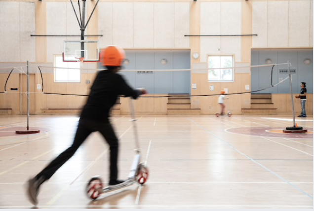 Children maintain social distancing while riding scooters indoors at emergency child care provided to health care workers in San Francisco at the beginning of the coronavirus pandemic in March. MUST CREDIT: Photo by Max Whittaker for The Washington Post