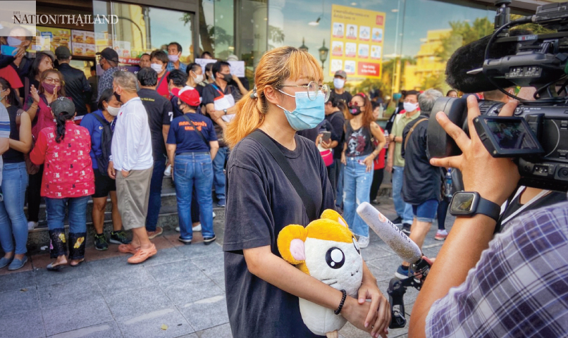 Pro-democracy protesters walk around  Democracy Monument on Sunday evening.