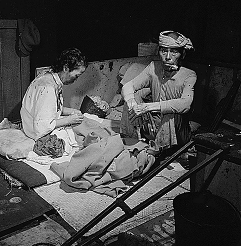 Blast victims live in a fly-infested hospital improvised in a bank building after the attack. MUST CREDIT: National Archives