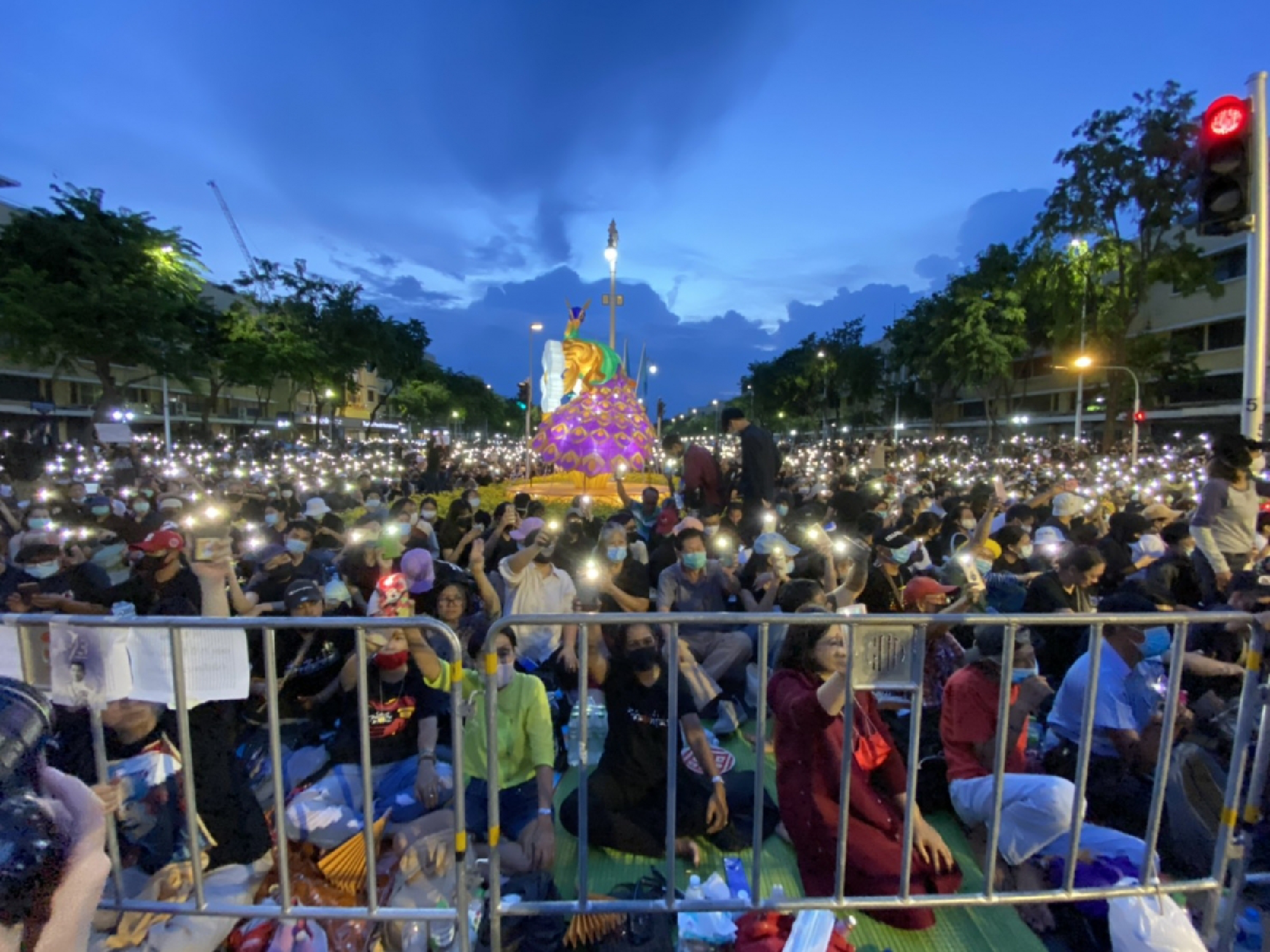 A huge crowd of student-led protesters are closing the roads around Democracy Monument in Bangkok