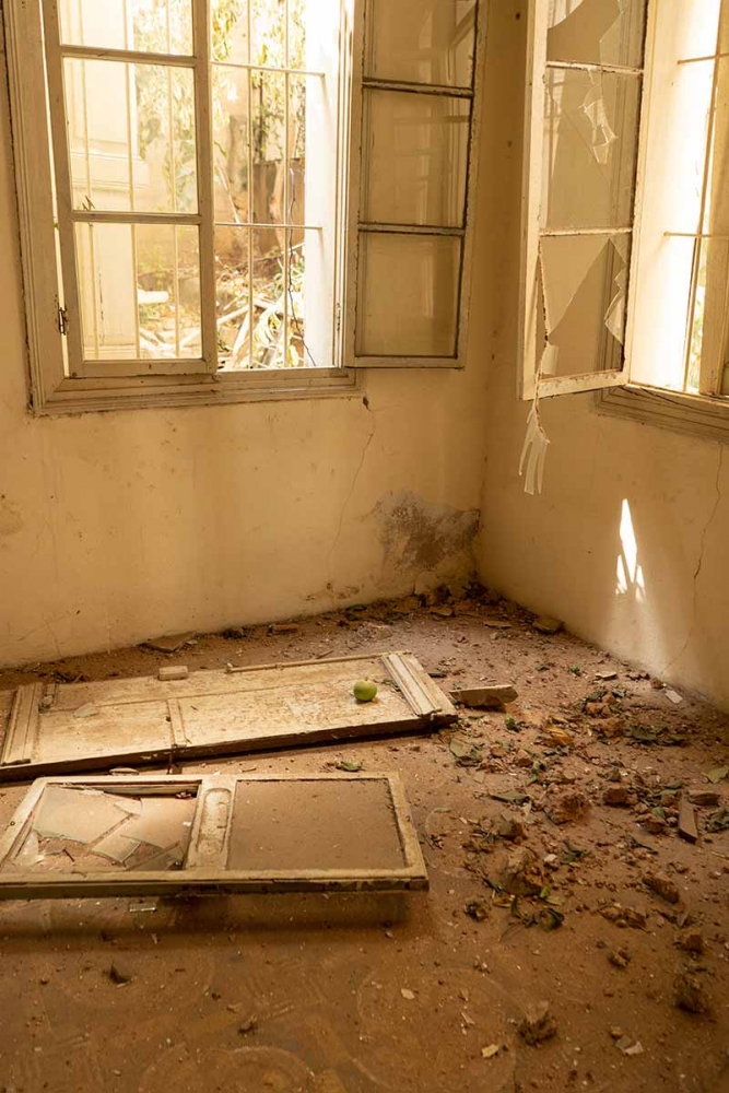 A green apple sits on a pile of debris in Henri Azar's damaged house. MUST CREDIT: For The Washington Post by Manu Ferneini