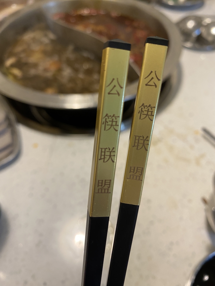 Chopsticks from Chengdu's "Public Chopsticks Alliance" have golden handles to remind diners which ones are for serving and which ones they can put in their mouths. MUST CREDIT: Washington Post photo by Anna Fifield.