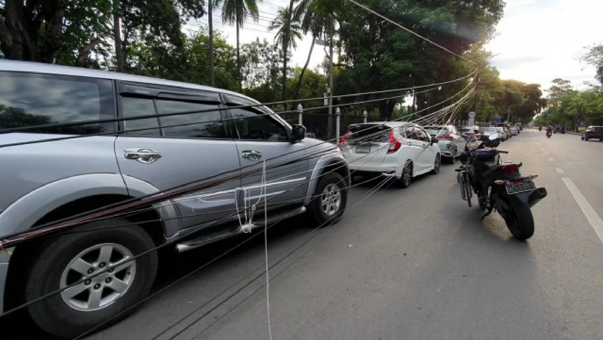Woman snarls up Chiang Mai traffic after knocking over 2 power poles