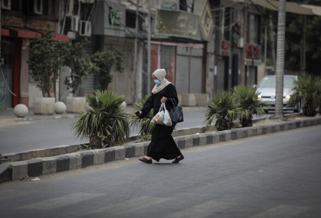A woman on Al-Nasr Street in Gaza City brings bread from a bakery back to her family on Sept. 10. CREDIT: photo for The Washington Post by Loay Ayyoub.
