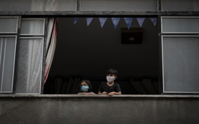 Children look out the window of their house in Gaza City on Sept. 9, amid a lockdown imposed due to the coronavirus. CREDIT: photo for The Washington Post by Loay Ayyoub.