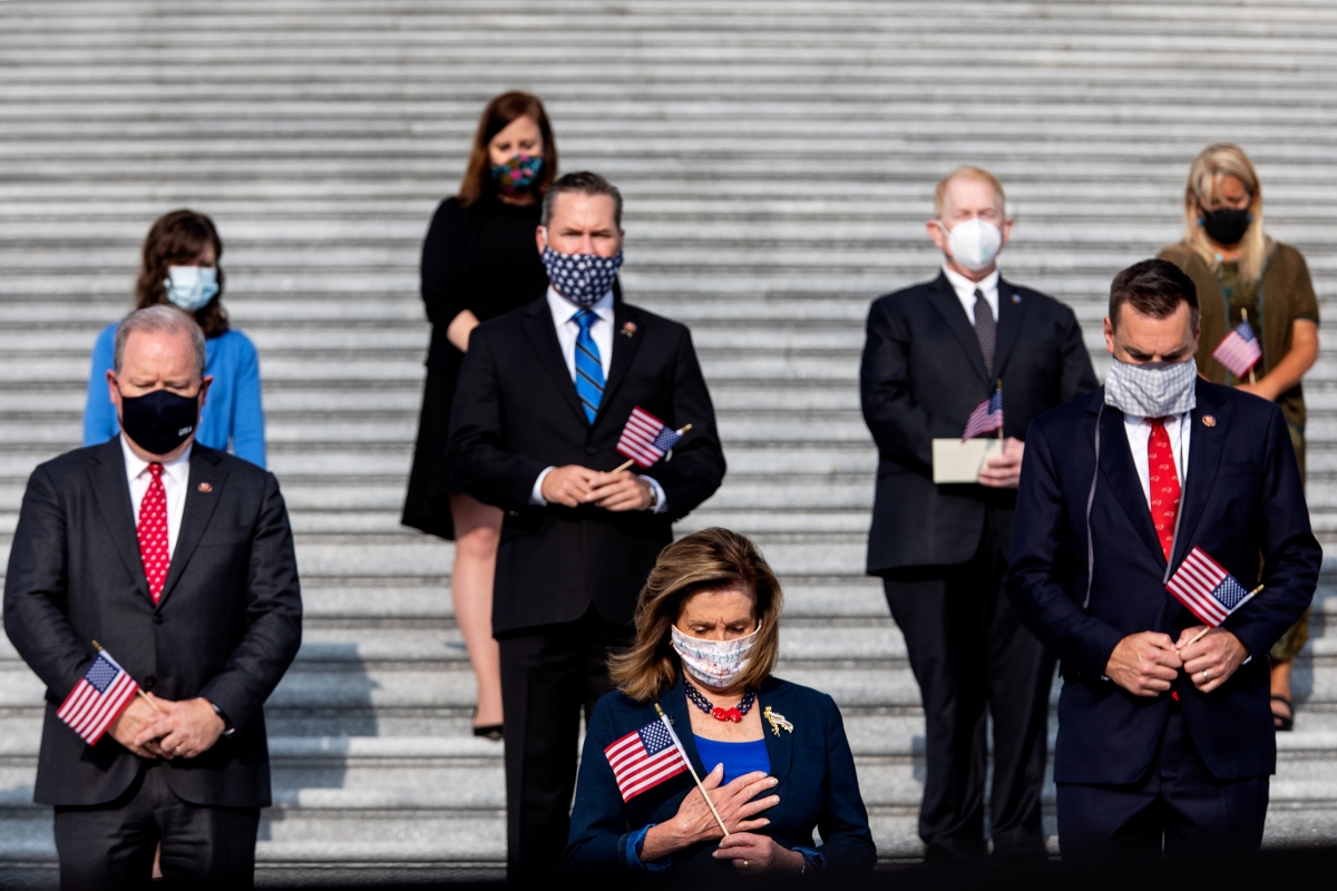 Members of Congress and staff stand for a moment of silence for the victims and family of 9/11 at the U.S. Capitol on Friday. MUST CREDIT: Washington Post photo by Demetrius Freeman
