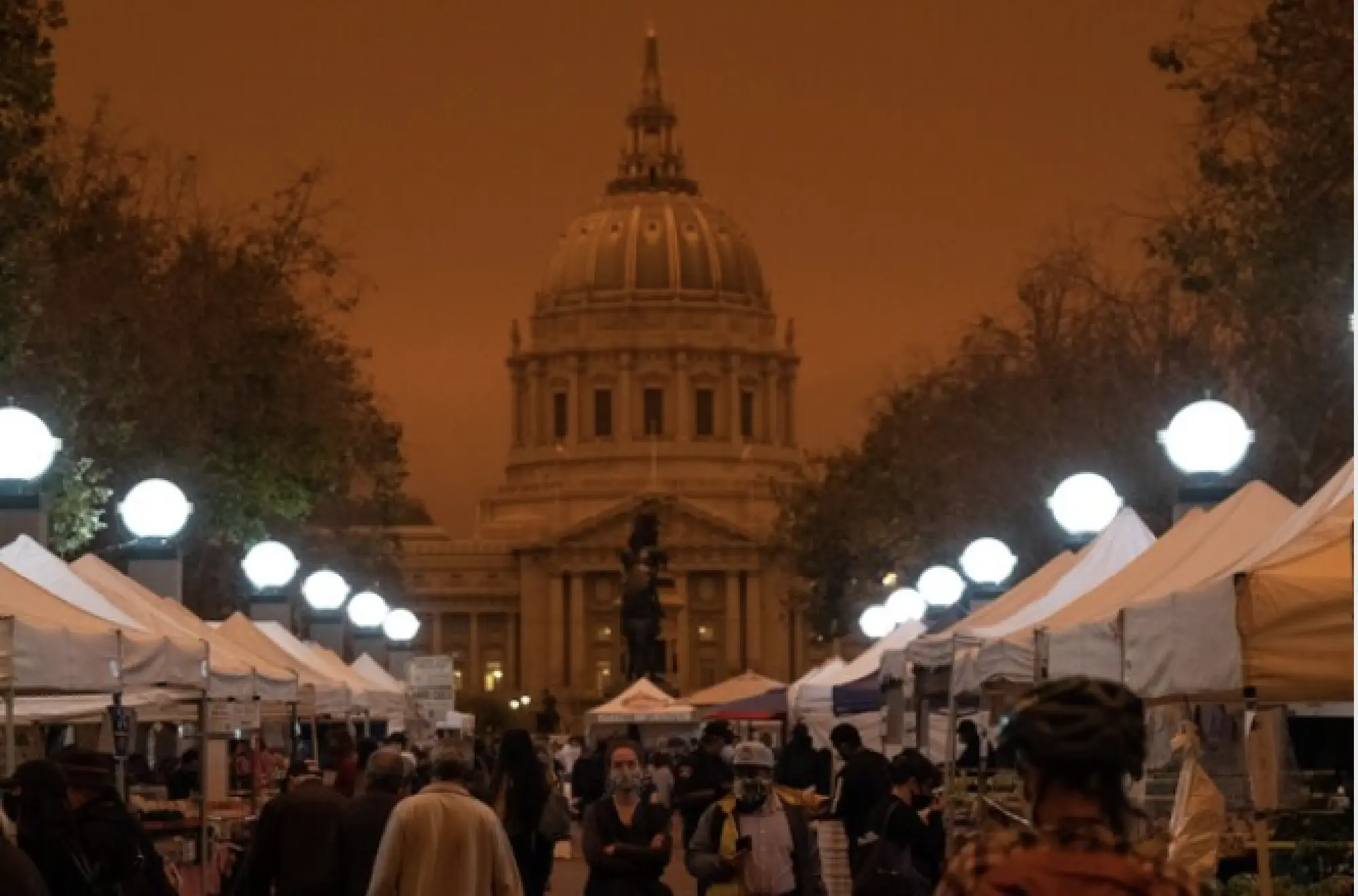 People shop at a farmers market near City Hall in San Francisco around 12:30 p.m. on Wednesday. CREDIT: Photo by Nick Otto for The Washington Post
