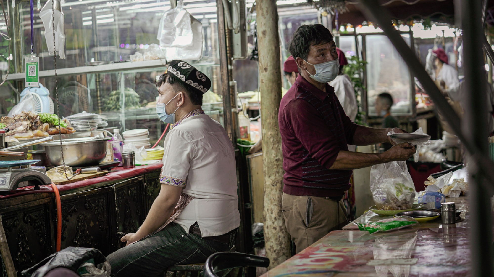 Stalls are open in the atmosphere market in the Old City of Kashgar, but vendors use knives that are chained to their counters, part of the government's efforts to thwart any kind of dissent. MUST CREDIT: Photo for The Washington Post by Lorenz Huber