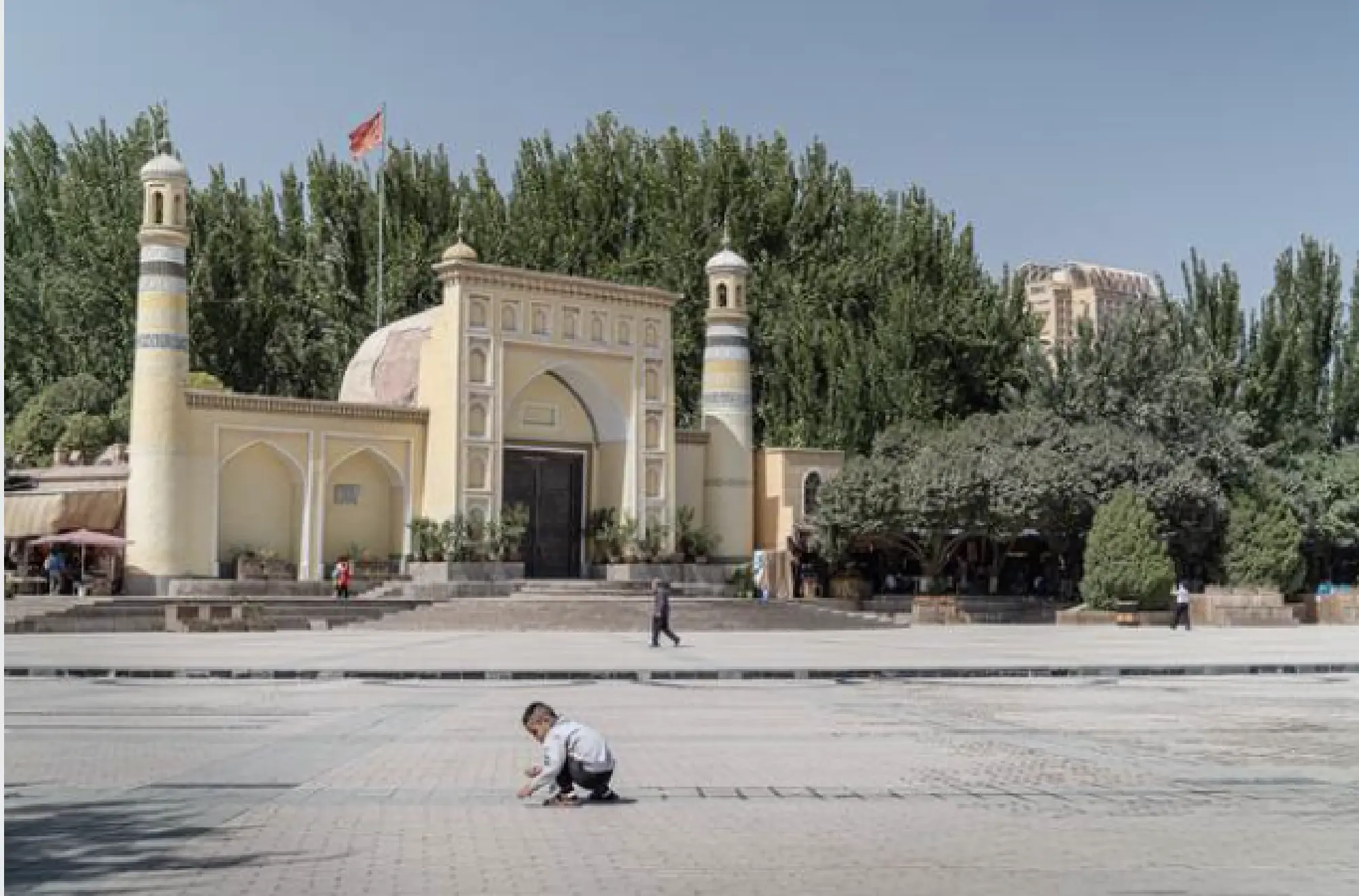 The Chinese flag hoisted above the famous Idkah mosque in Kashgar stands taller than the crescents and minarets, a way to show which institution is pre-eminent. MUST CREDIT: Photo for The Washington Post by Lorenz Huber